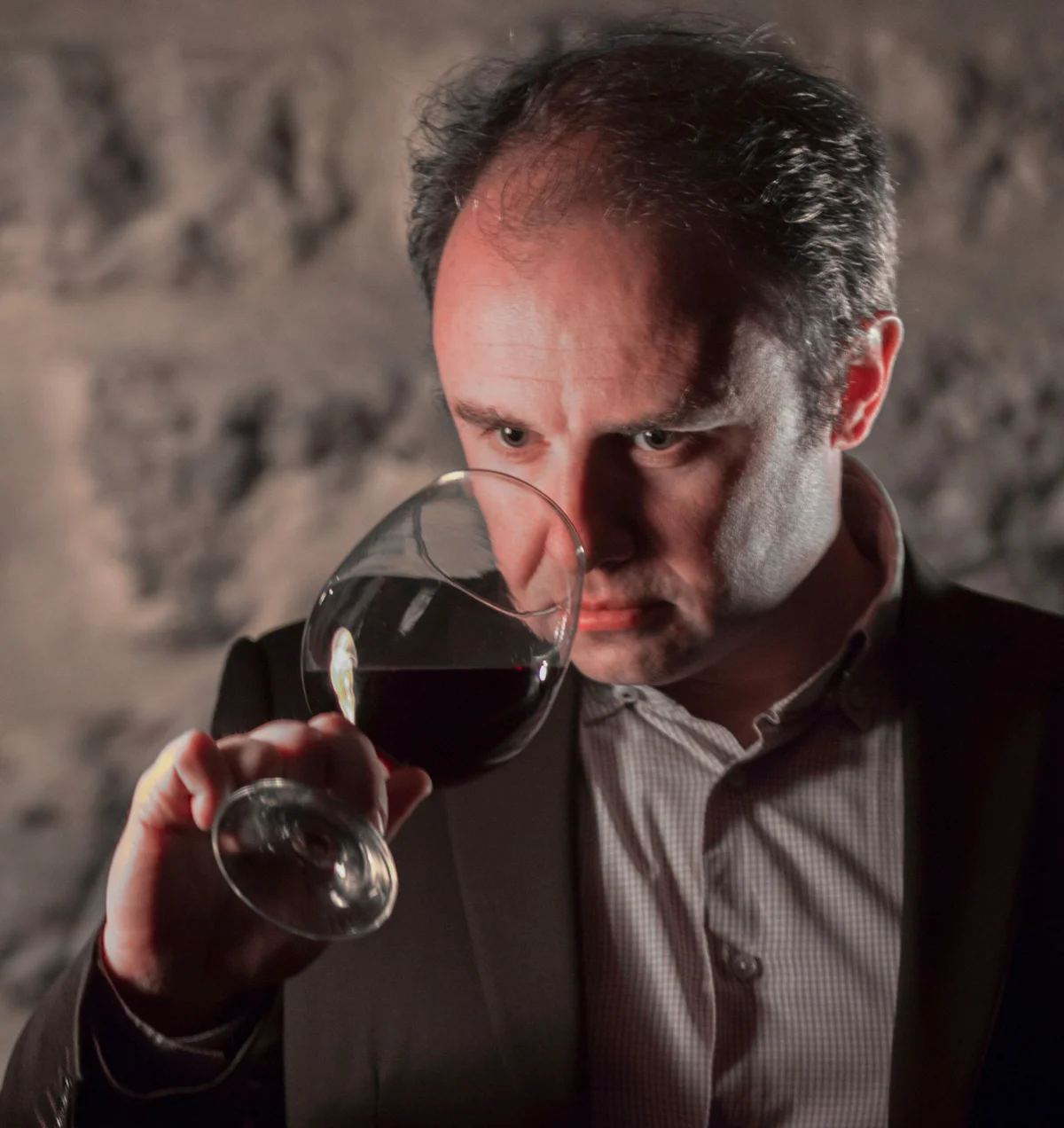 A guest smelling a glass of wine during a tasting