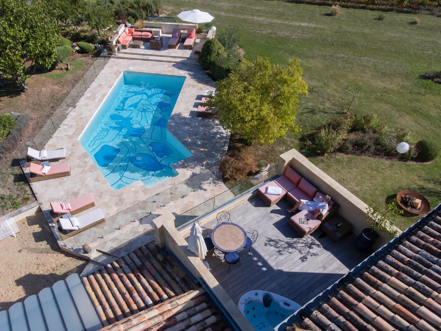 A woman lying on the terrace of Palanquey, near the swimming pool and jacuzzi